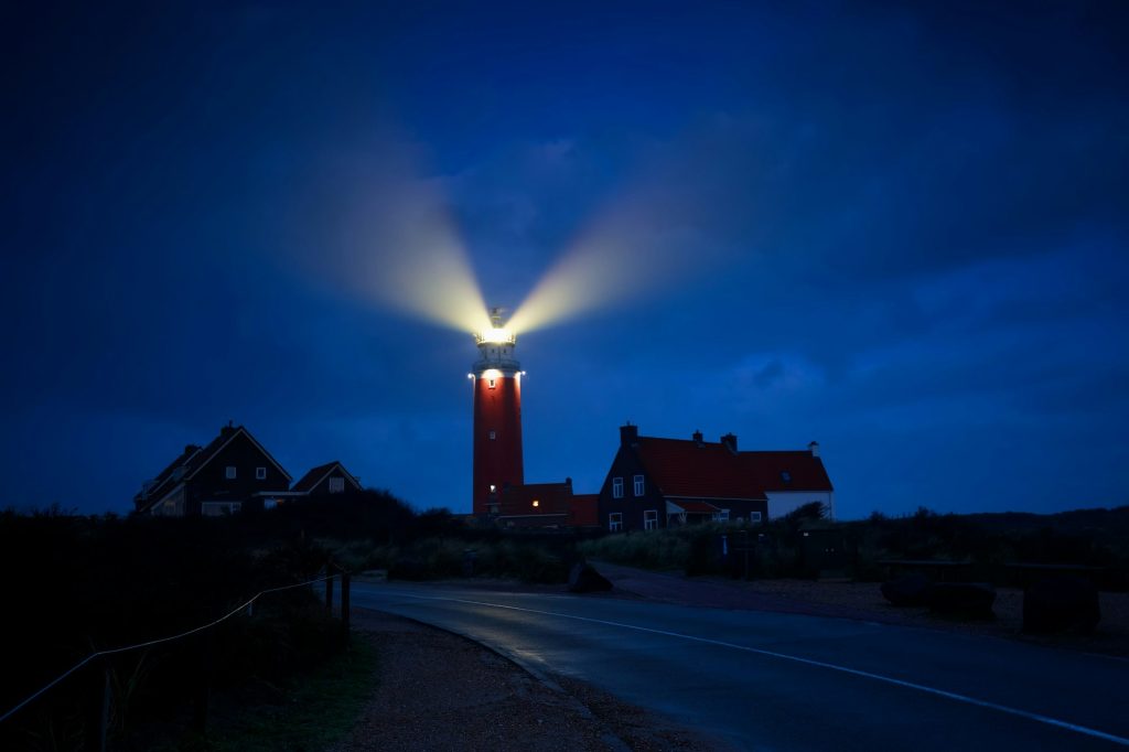 lighthouse lightbeams in night